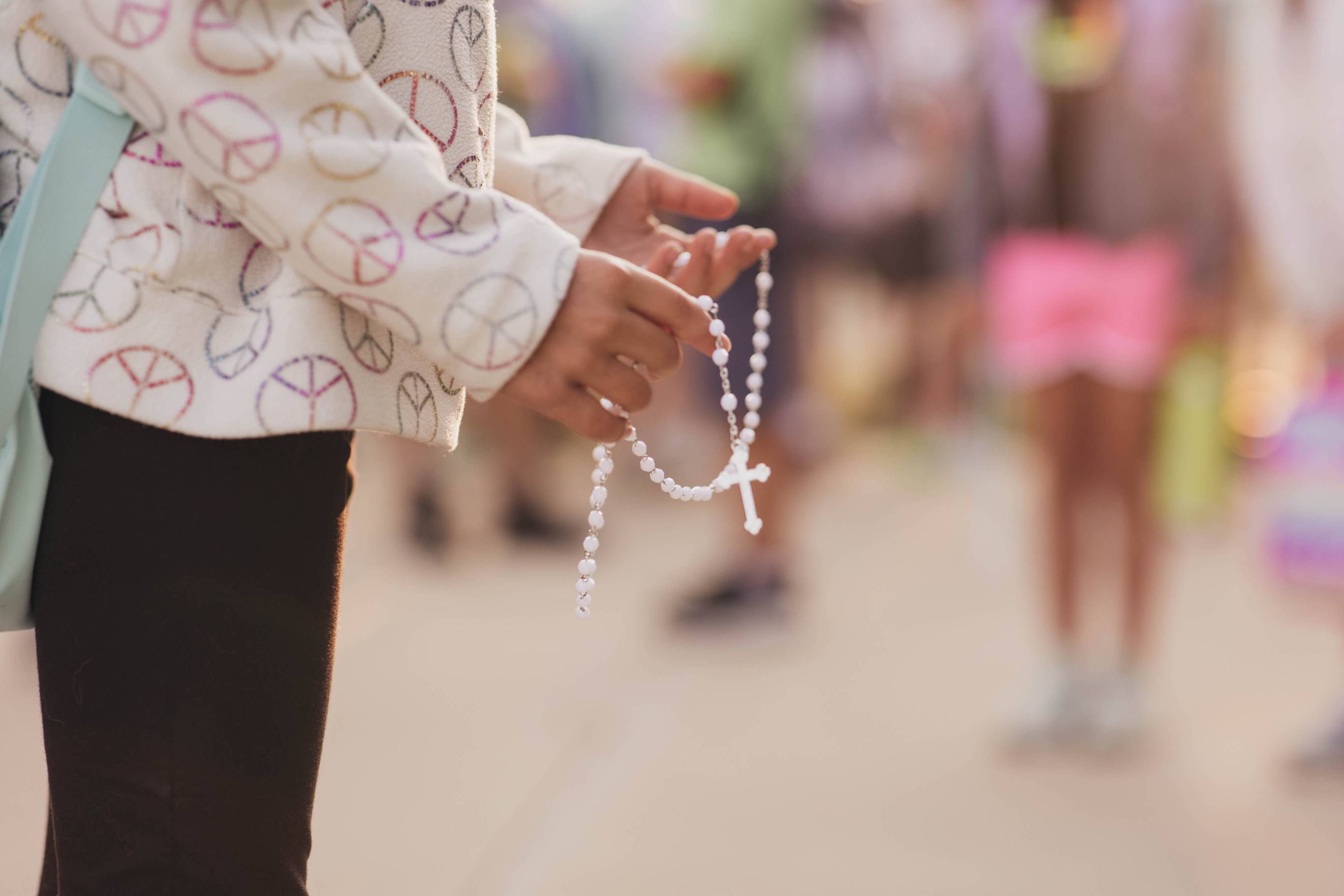 Hands holding a rosary