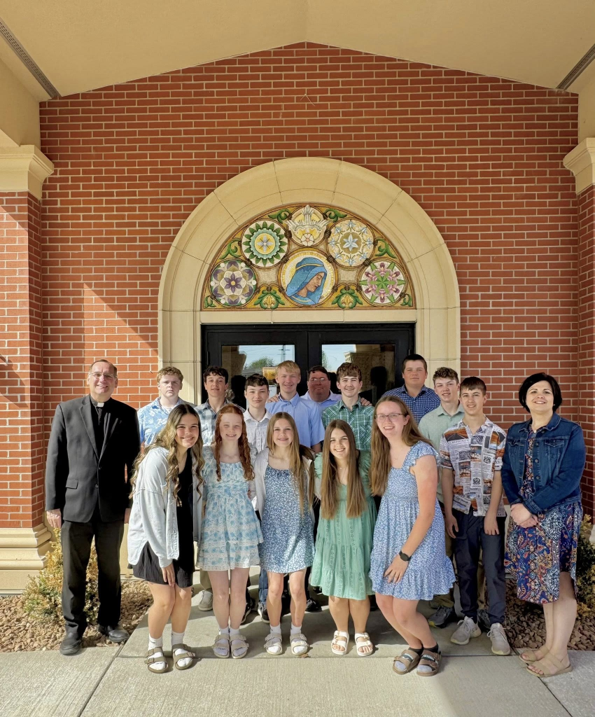 Father Berning and Principal Schaefer with Sacred Heart Students in Adams, MN
