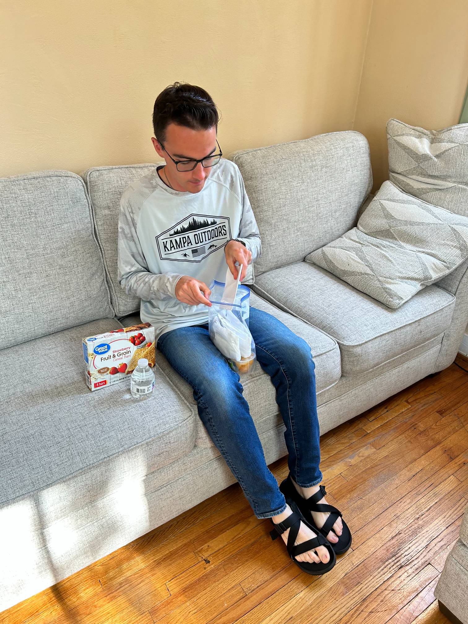 Seminarian assembles Blessings Bag on couch