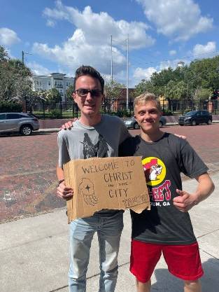 Seminarians holding Welcome to Christ in the City sign
